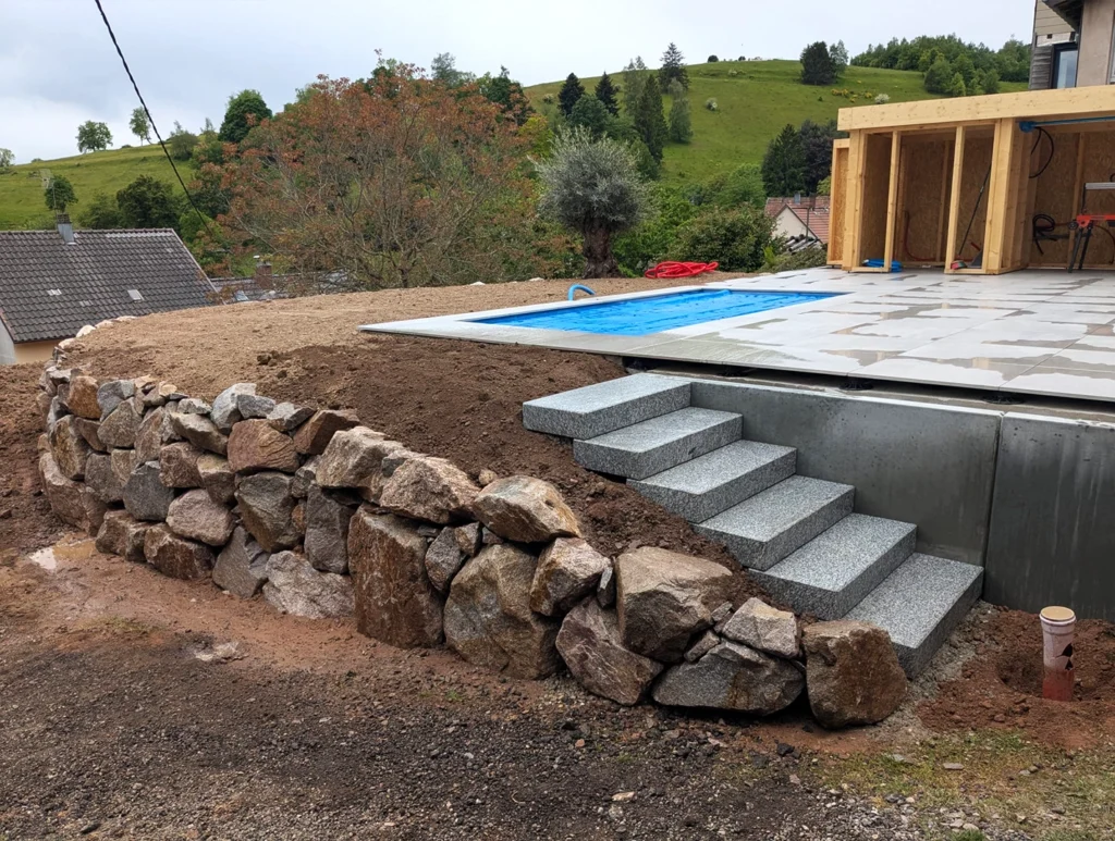Aménagement d'un escalier pour accès à terrasse de piscine sur terrain en pente, à Grendelbruch